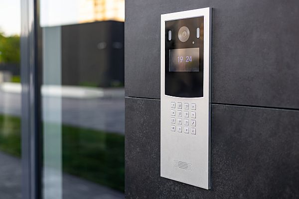 Video intercom panel adjacent glass door